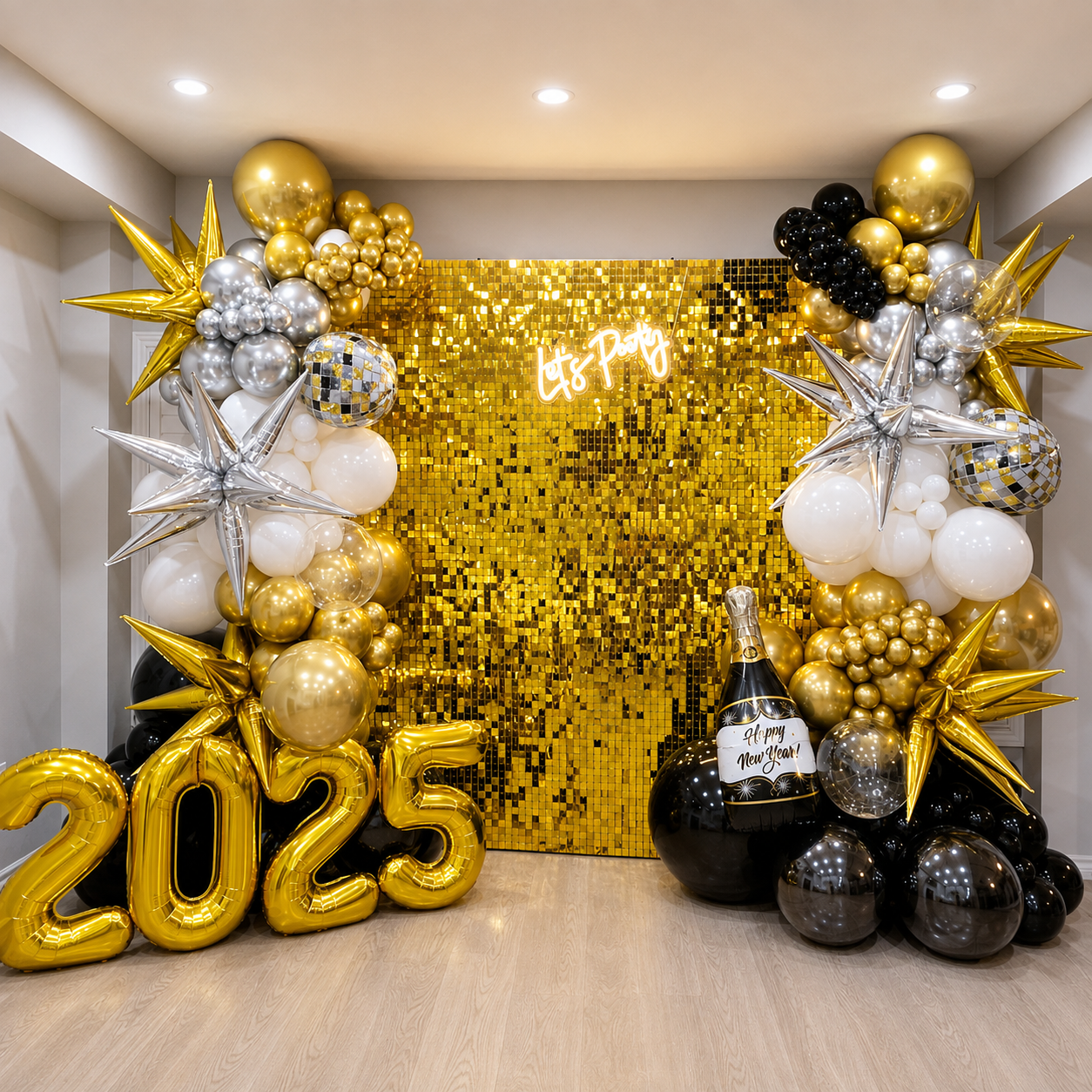 New Year’s Eve 2025 party backdrop featuring a gold shimmer wall, black, white, silver, and gold balloon garlands, metallic star balloons, disco ball accents, champagne decor, and large gold 2025 balloons.
