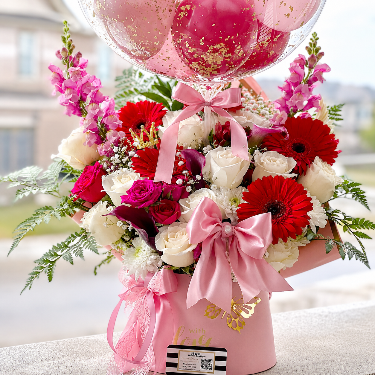 Birthday gift for Grandma featuring a personalised clear balloon, red and pink balloons, red and white flowers, butterflies, and pink ribbon accents.