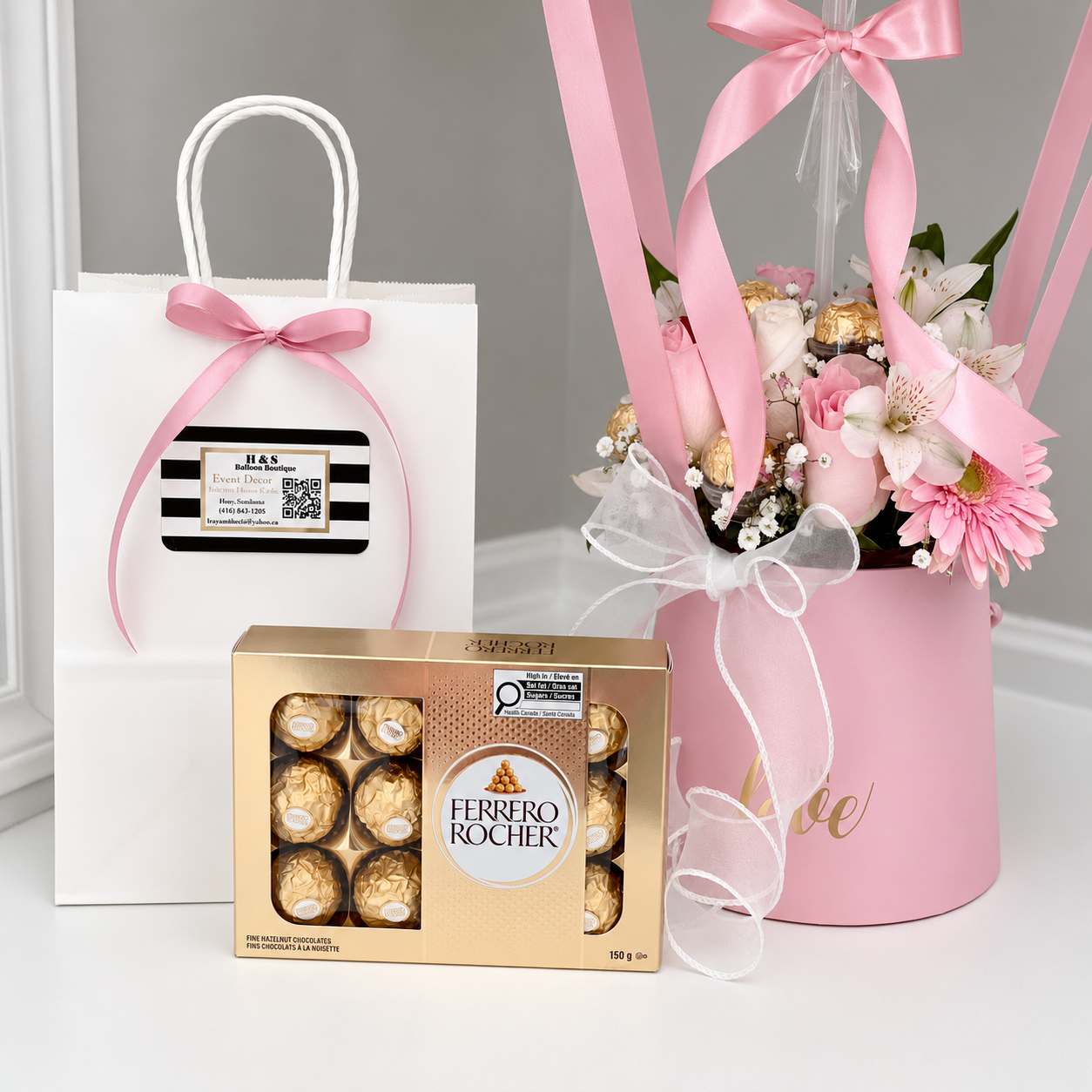 Mother’s Day gift arrangement featuring a personalised pink balloon, fresh flowers, Ferrero Rocher chocolates, ribbons, and a gift bag.