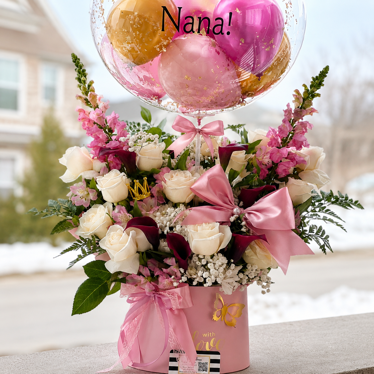 65th birthday gift for Nana featuring a personalised clear balloon, pink and gold balloons, white and pink flowers, butterflies, and elegant ribbon accents.