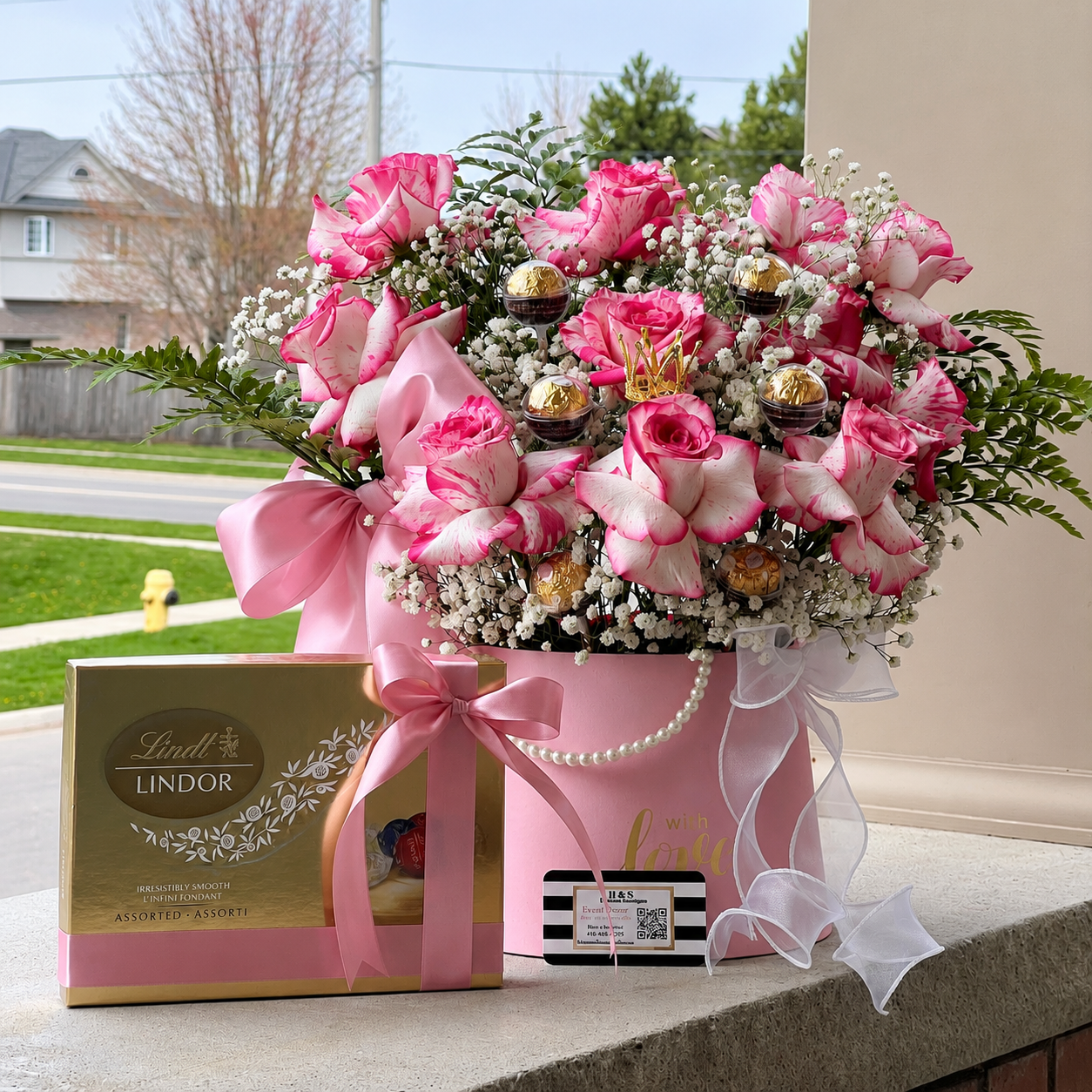 Birthday gift for a sister featuring pink roses, Lindor chocolates, a personalised clear balloon, and pink and gold decorations.